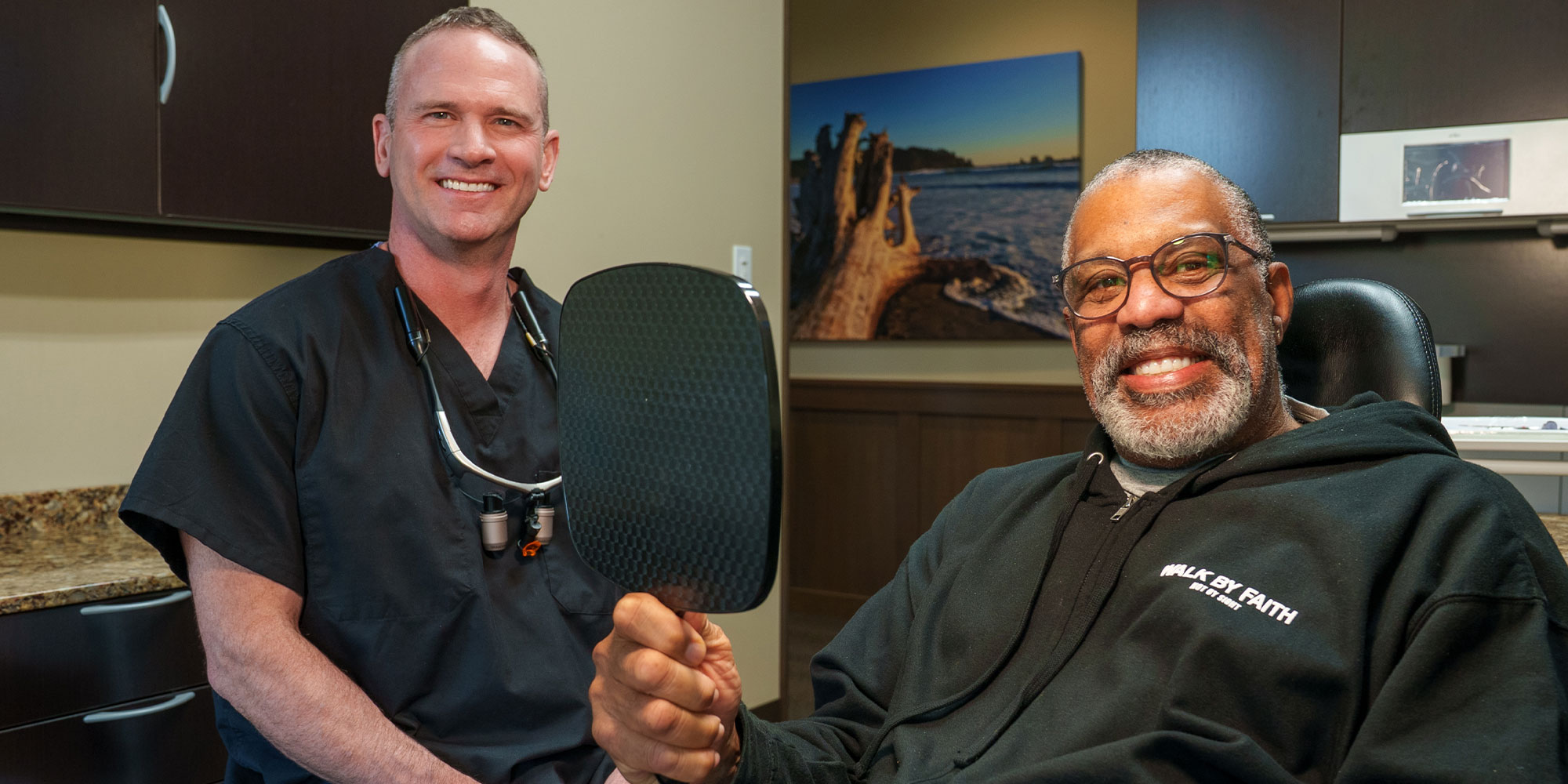 Patient smiling into mirror